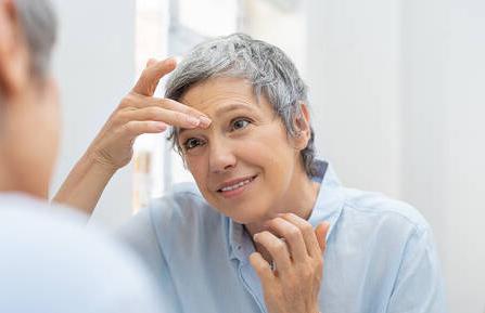 Older woman looking in mirror